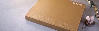 Travel box on white painted floor with childrens toys around